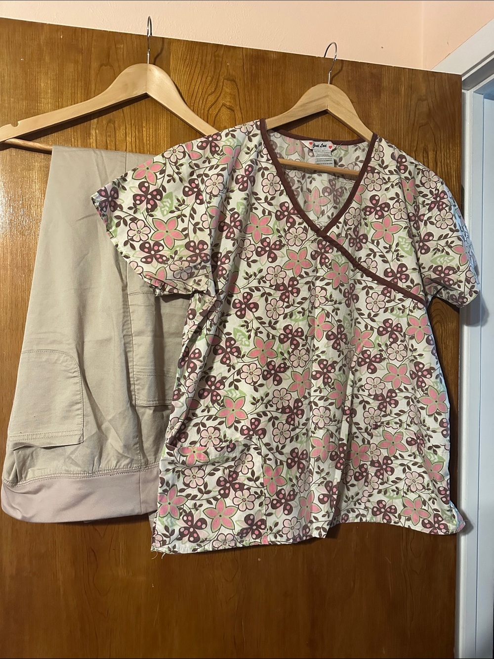 Floral V-Neck Scrub Top in Pink, Tan and Brown pairs with tan Scrub pants.